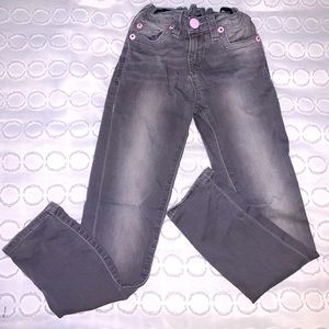 Gray True Religion Jeans pink trim.